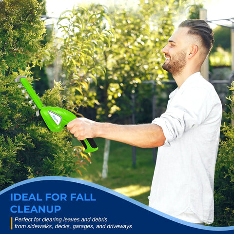 Man using Quick Change Blade Cordless Garden Shears For Snipping Grass And Trimming Hedges in a lush garden.