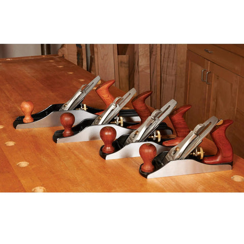 Heirloom Grade Bench Plane Set Featuring Number Three Four Five And Six Hand Tools on a workbench with ergonomic handles.