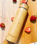 Premium 17 Oz Bamboo Tea Tumbler With Removable Loose Leaf Infuser double wall, bamboo material, surrounded by strawberries.