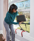 Woman deploying Three Story Fire Escape Ladder 24 Feet Steel With Slip Resistant Rungs And Stabilizers Black Built Tough And Ready To Roll