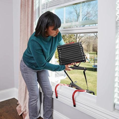 Woman deploying Three Story Fire Escape Ladder 24 Feet Steel With Slip Resistant Rungs And Stabilizers Black Built Tough And Ready To Roll