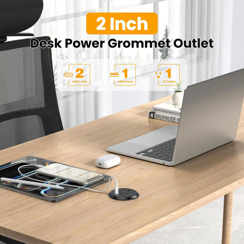 Sleek 2 Inch Desk Power Grommet Outlet With AC Receptacle And Multiple USB Ports on wooden desk with laptop and phone.