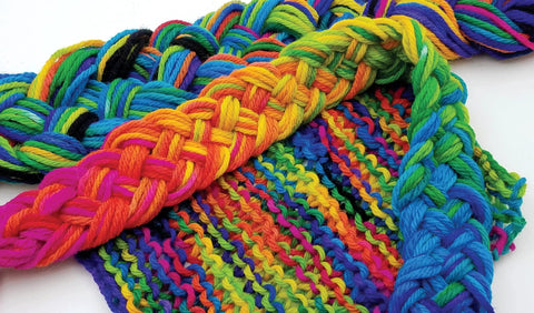 Yarn skeins braided in rainbow colors; bright multicolor wool blend.