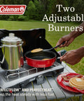 Two-Burner Propane Camp Stove With InstaStart Ignition And Wind Guards in use, cooking pancakes in the outdoors.