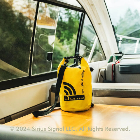 All In One Boating Safety Dry Bag Kit With IP68 Waterproof Flashlight on a boat table, yellow with black strap