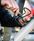 Using 8 In 1 EDC Multitool Pocket Knife with quarter inch bit driver on a bicycle, burnt orange handle visible