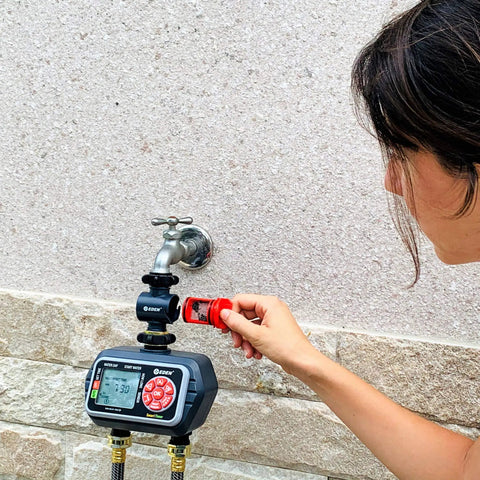 Person installing inline water filter for garden hoses and tools anti rust stainless steel 50 mesh screen high flow 11 GPM.