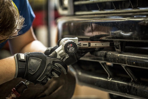 Air Belt Sander 1/2 Inch By 18 Inch Workhorse 0.5 HP used for spot weld removal on car bumper, showing ergonomic grip