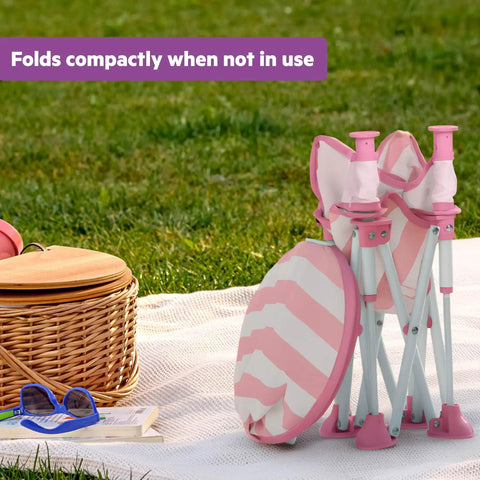 Folded Pop N Sit Cabana Baby Beach Portable Booster Chair with UPF Canopy next to picnic basket on grass