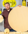 Person holding a large and a small circle cut from wood using the Rock Solid Router Circle Cutting Jig And Dead On Precision Router Guide For Flawless Rings Across 276 Exact Sizes Fits Most Plunge Routers With Heavy Duty Clear Acrylic Base For Stress Free Shop Project Builds.
