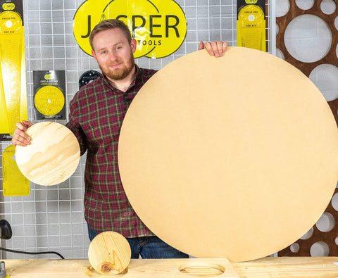 Person holding a large and a small circle cut from wood using the Rock Solid Router Circle Cutting Jig And Dead On Precision Router Guide For Flawless Rings Across 276 Exact Sizes Fits Most Plunge Routers With Heavy Duty Clear Acrylic Base For Stress Free Shop Project Builds.