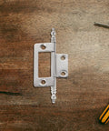 16 Piece Nickel Plated Concealed Cabinet Hinges, 2 Inch Flush Mount Butt Hinges for wood boxes, close-up on wood surface.