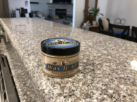 Real Deal Food Grade Beeswax Wood Polish And Cutting Board Wax, Nine Oz Jar on a polished granite countertop.