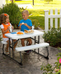 Kids enjoying snacks at Kids Picnic Table With One Hand Adjustable Squeeze Button Setup Folds Flat For Easy Transport.
