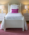 Bedroom with white bed and pink accents, featuring Felix LED Ceramic Table Lamps Set Of 2 in Antique Brass Finish with White Linen Hardback Shade on nightstands.