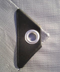 Close-up of grommet on Heavy Duty Dry Top Poly Tarp 12x24 Foot Multi Purpose Shelter Cover Silver and Brown Waterproof Tarp.