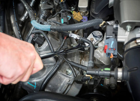 Hand using Three Eighth Inch Drive Ratchet And Drive Tools Set With Eighty Four Tooth Full Polish Chrome Ratchets on engine bolts