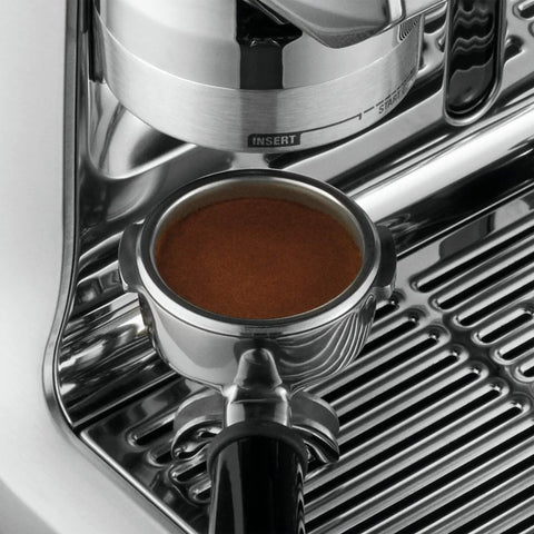Heavy Duty Fully Automatic Espresso Machine With Slick Touchscreen Interface And Pro Grade Dual Boiler Rig For Killer Specialty Coffee At Home Featuring Precise Thermal Regulation And Smooth Simultaneous Brewing close-up of portafilter with ground coffee.