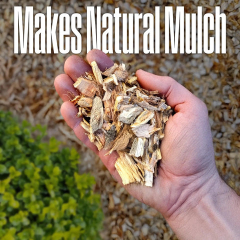 Hand holding mulch from Corded Electric Wood Chipper Shredder Be The Yard Boss With 1.7 Inch Capacity And 15 Amp Motor