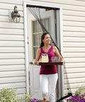 Woman carrying tray through Portable Doorway Screen Curtain 38 by 81 Inches, tool free install, charcoal.