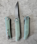 Open and closed views of green folding knife with textured handle, compact EDC blade for everyday tasks, packages, camping and outdoors.