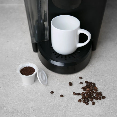 Disposable Paper Coffee Filters 300 Count Compatible With Keurig And K Cup Machines next to coffee maker and beans