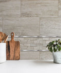 Kitchen backsplash with Soho Listel Low Pencil Tile Trim One Half Inch By 12 Inch Brushed Nickel Decorative Edge for ceramic tile surfaces.
