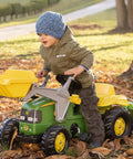 Child playing outdoors on Pedal Tractor With Working Front Loader And Detachable Trailer For Kids Ages 3 And Up Realistic Farm Ride On Toy