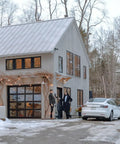 Portable Level 1 And 2 Ev Charger 40 Amp With Nacs Connector For Tesla at modern home with snowy driveway.