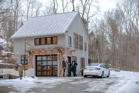 Portable Level 1 And 2 Ev Charger 40 Amp With Nacs Connector For Tesla at modern home with snowy driveway.