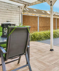 Beefy 4x4 Post Bases With Brackets And Internal Railing Anchors For 3.5x3.5 Wood Posts on wooden deck with green chairs