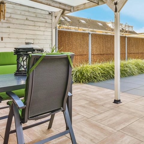 Beefy 4x4 Post Bases With Brackets And Internal Railing Anchors For 3.5x3.5 Wood Posts on wooden deck with green chairs