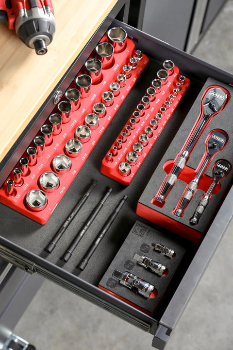 Top view of an organized tool drawer containing various socket wrenches, ratchets, and bits arranged neatly in red holders.