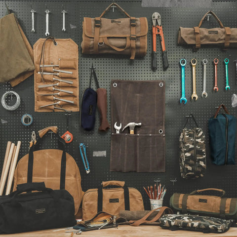 Heavy Duty Waxed Canvas Tool Roll Bag With 24 Pockets Roll Up Pouch For Wrenches And Tools Waterproof 16oz Canvas displayed on pegboard