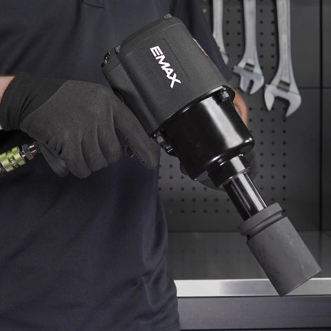One Inch Drive Air Impact Wrench Packs Ball Bearings And Aluminum Body pumping twisting force with a gloved hand.