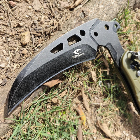 Close-up of Folding Sickle Knife With Sheath For Tactical Survival And Outdoor Pruning Tools on ground, blade detail