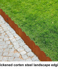 Cor Ten Steel Landscape Edging Kit 20 Ft with Rustic Scalloped Metal Border separating grass from cobblestone path.