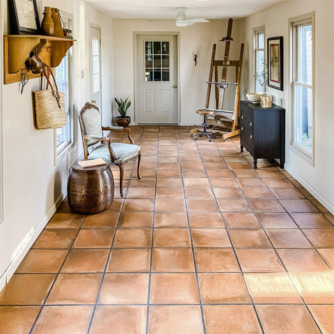 Rustic Cotto 13x13 Porcelain Tile For Floor And Wall, Glazed Textured Finish, installed in a sunlit hallway with furniture.