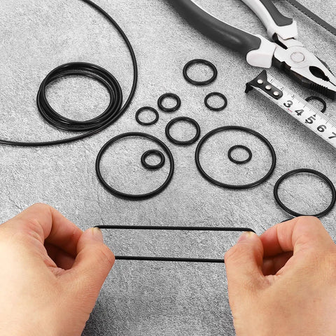 Hands stretching 100 Pcs Nitrile O-Rings 1/2 In ID, 11/16 In OD, 3/32 In Thick, 70 Durometer Black Sealing Gaskets For Automotive, Machinery, And Plumbing Oil Resistant, Wear-Resistant, Leak-Proof, Flexible Repair Kit with tools.