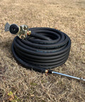 Heavy Duty Truck Tire Inflator Kit With 3/8 By 50 Ft Hybrid Air Hose, Glad Hand Connector And Air Chuck coiled on dry grass.