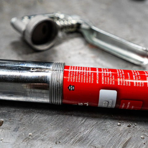 Close-up of Sticky Red Lithium Complex Multipurpose Grease 3 oz tube, water resistant heavy duty for auto equipment and farm gear.