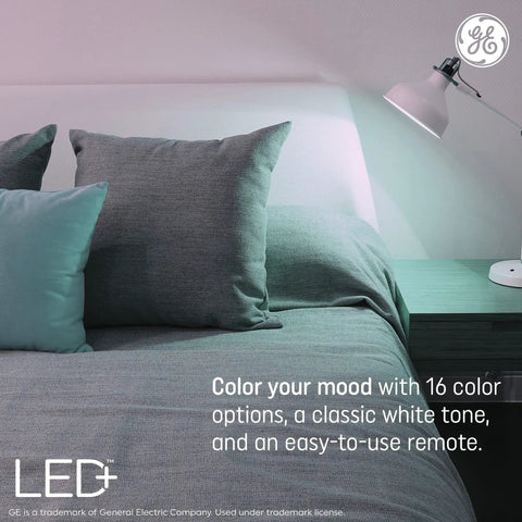 Color Changing LED Light Strip With Remote 32 Feet Of Lit Mood Lighting illuminating a bedroom with pillows and a lamp