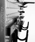 Close-up of Three Pack Pegboard Set, 16 Inch Tall By 32 Inch Wide Steel Wallboards with hooks and slots for tool storage.