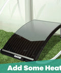 Curved solar pool heater panel on grass with hoses connected, designed to increase pool water temperature efficiently.
