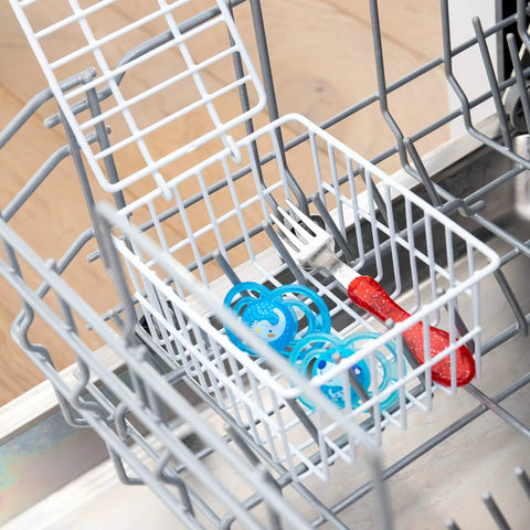 White Coated Steel Cabinet Organizer Basket With Snap Lid holding items in dishwasher, showcasing durability and storage function.