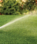 Pro Grade Gear-Drive Rotor With Rain Curtain Nozzles Set spraying water on lawn, 40 To 360 Degree Pattern, 19 To 32 Feet Spray Radius.