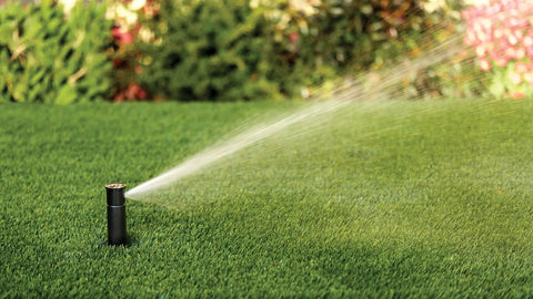Pro Grade Gear-Drive Rotor With Rain Curtain Nozzles Set spraying water on lawn, 40 To 360 Degree Pattern, 19 To 32 Feet Spray Radius.