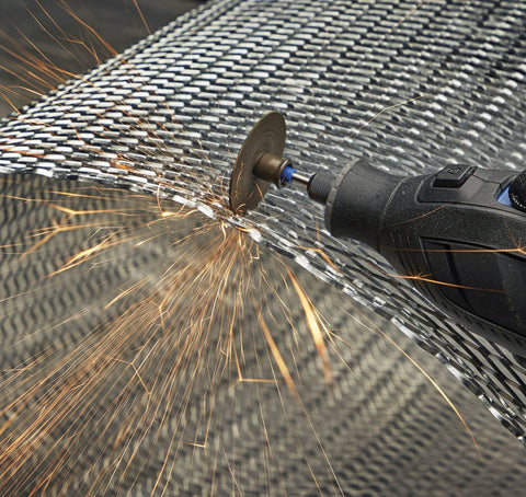 Rotary tool with a 1.5-inch cut-off wheel cutting metal mesh, sparks flying.