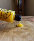 Orange Oil Wood Cleaner With Beeswax Preserver and Conditioner for Hardwood Floors Cabinets and Furniture being used on table surface.