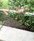 One Half Inch Compact Bronze Double Check Backflow Preventer Featuring Top Access Modularity And Stainless Steel Ball Valves For A No Fuss Plumbing Setup displayed outdoors.